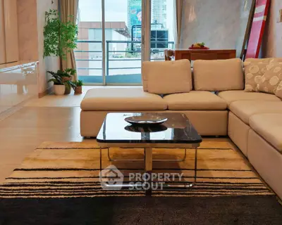 Spacious living room with modern decor and balcony view