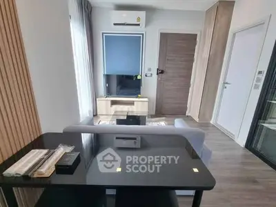 Modern living room with sleek furniture and air conditioning in a stylish apartment.