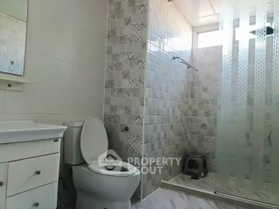 Spacious bathroom with modern shower and elegant tile design