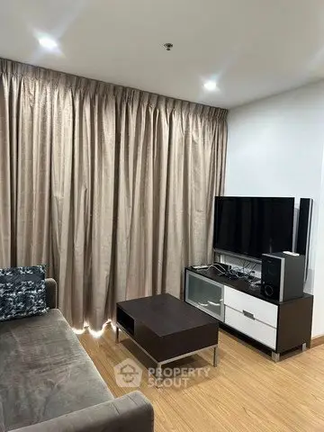 Modern living room with sleek furniture and large curtains, perfect for cozy evenings.