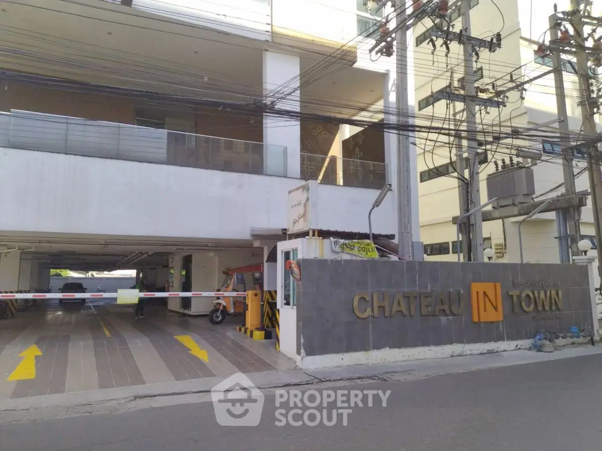 Modern condominium entrance with secure parking and stylish signage.
