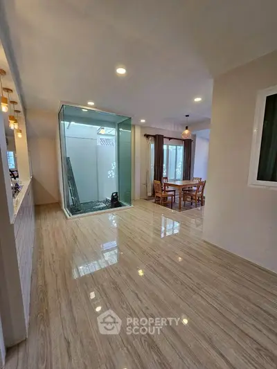 Spacious modern living area with elegant flooring and natural light