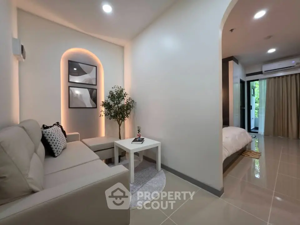 Modern living room with cozy seating and elegant decor in a stylish apartment.