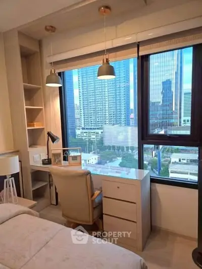 Modern bedroom with city view, featuring a cozy study nook and elegant lighting.