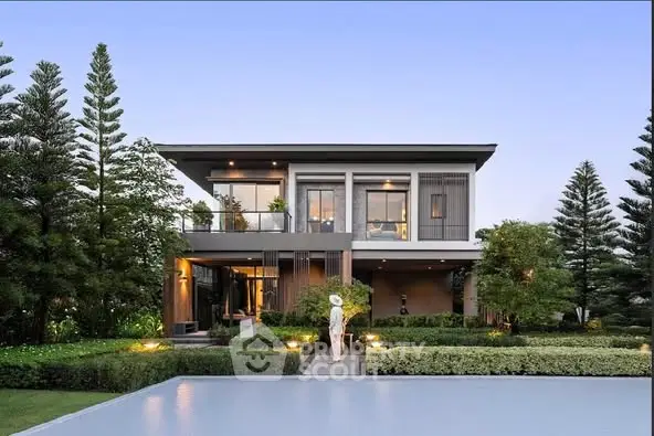 Modern luxury home with lush garden and poolside view, perfect for serene living.