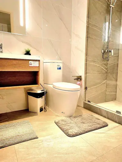 Modern bathroom with sleek design, featuring a glass shower, elegant tiles, and contemporary fixtures.