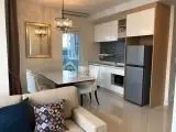 Modern open-layout kitchen and dining area with stylish decor and appliances.