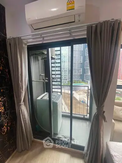 Modern apartment balcony with air conditioning unit and city view, perfect for urban living.