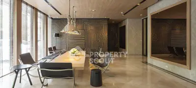 Luxurious modern lobby with stylish seating and geometric wall design, perfect for upscale living.