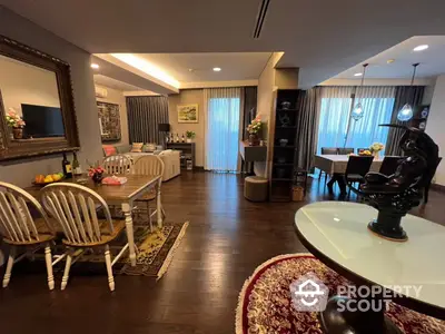 Spacious and elegantly furnished open-plan living area with classic dining set, plush seating, and tasteful decor, perfect for entertaining and comfortable living.