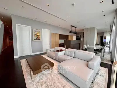 Luxurious modern living room with sleek furniture and open kitchen layout