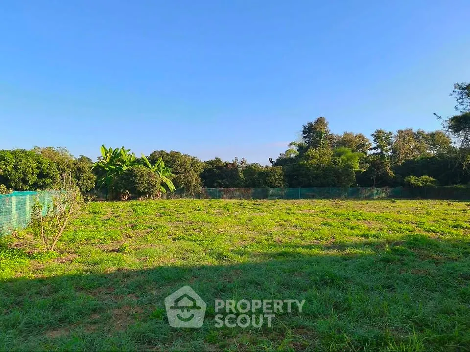 Expansive green land plot with lush surroundings, perfect for development or agriculture.