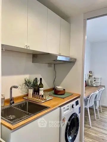 Charming kitchen with modern appliances and cozy dining area, perfect for urban living.