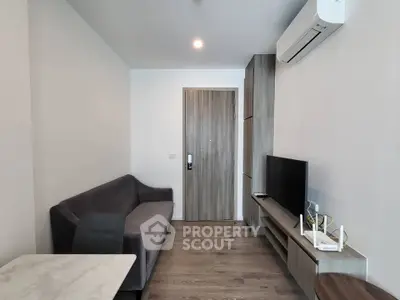 Modern living room with sleek furniture and air conditioning in a cozy apartment.