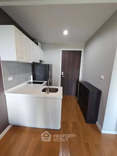 Modern kitchen with sleek cabinetry and hardwood flooring