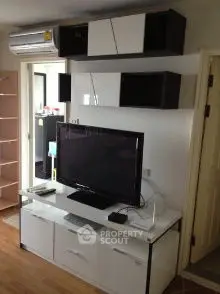 Modern living room with sleek TV setup and stylish storage units.