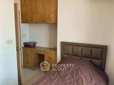 Cozy bedroom with wooden cabinetry and modern headboard, perfect for a restful retreat.