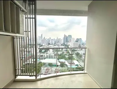 Stunning city view from modern apartment balcony with glass railing.