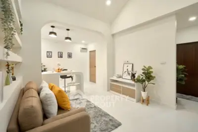 Modern open-plan living room with cozy seating and stylish decor, perfect for relaxation and entertaining.