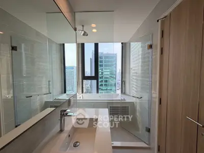 Luxurious bathroom with city view, featuring modern fixtures and glass shower enclosure.