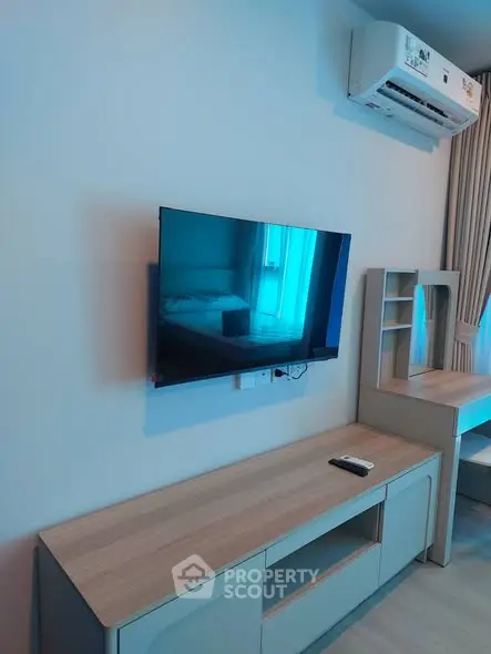 Modern living room with wall-mounted TV and sleek furniture