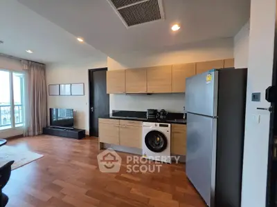 Modern open-layout kitchen with wooden cabinets and integrated appliances in a stylish apartment.