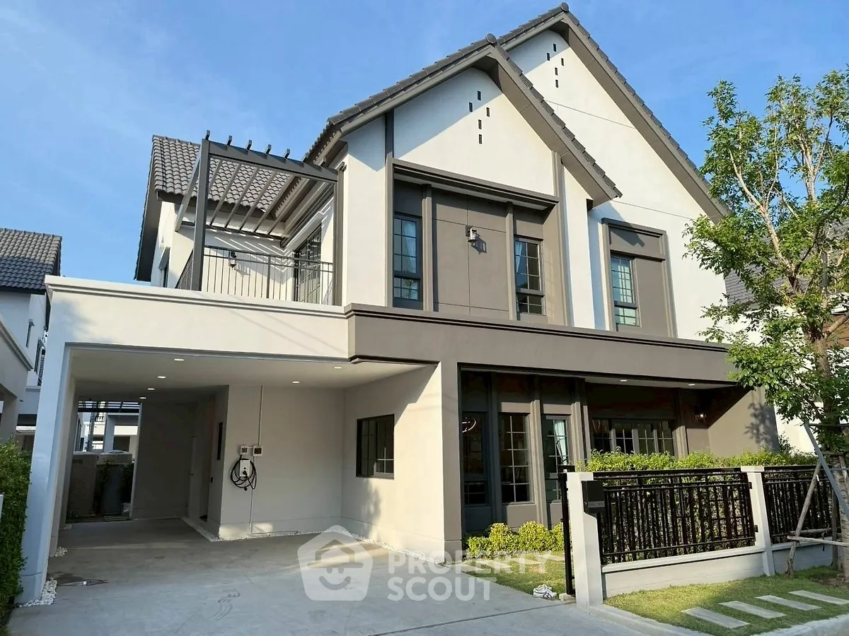 Modern two-story house with spacious driveway and lush greenery