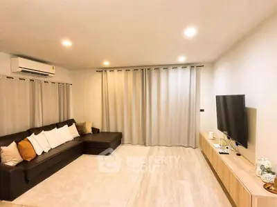 Modern living room with cozy sectional sofa and large TV setup