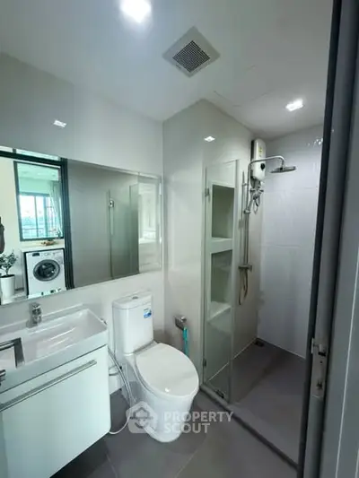 Modern bathroom with shower and washing machine view