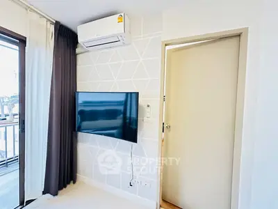 Modern living room with wall-mounted TV and air conditioning unit