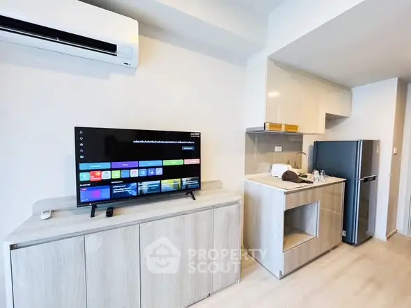 Modern apartment interior with sleek kitchen and entertainment area