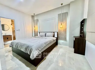 Modern bedroom with elegant lighting and stylish furnishings