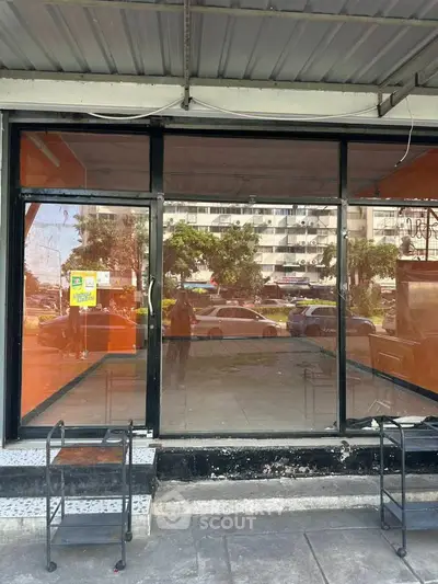 Vacant commercial space with large glass storefront in urban area