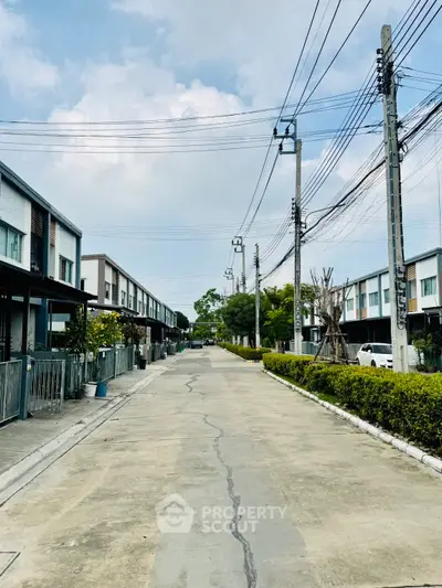 Charming residential street with modern townhouses and lush greenery, perfect for family living.