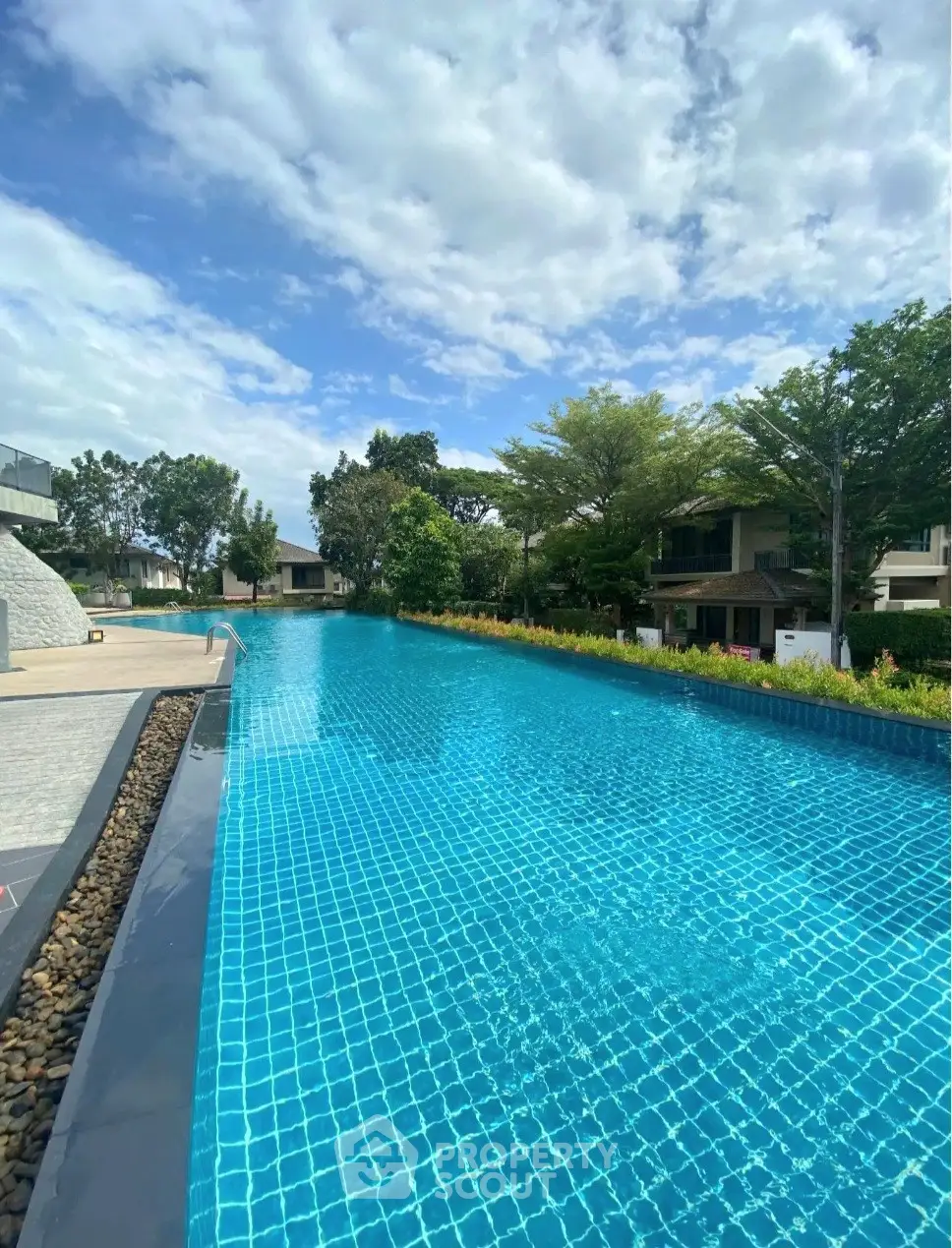 Luxurious infinity pool with serene surroundings and lush greenery, perfect for relaxation and leisure.