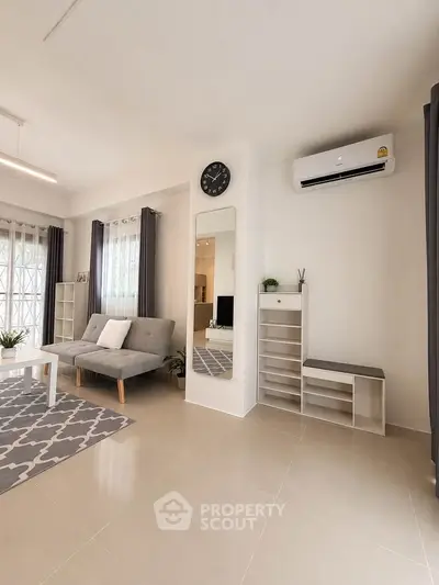 Modern living room with sleek furniture and air conditioning, perfect for comfortable living.