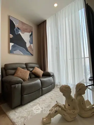 Stylish living room with modern art and cozy seating in a bright apartment.