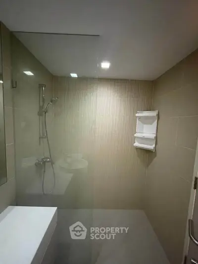 Modern bathroom with sleek shower and minimalist design in a contemporary apartment.
