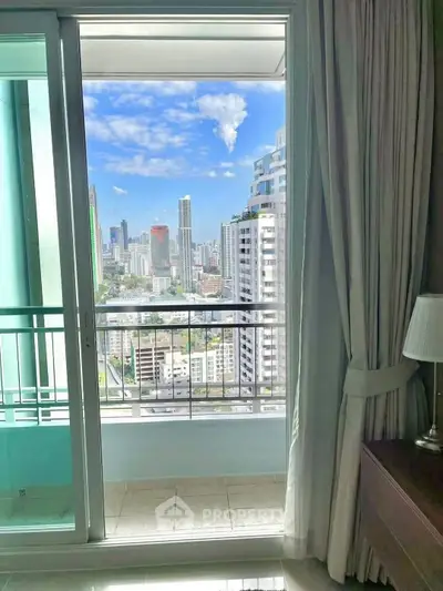 Stunning city view from a modern apartment balcony with clear blue skies.