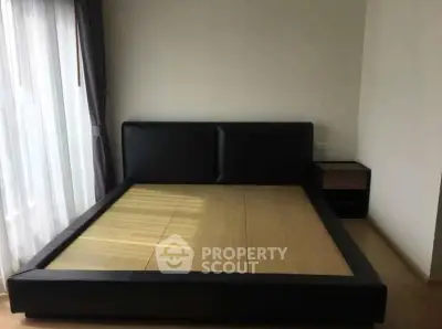 Spacious bedroom with modern bed frame and natural light