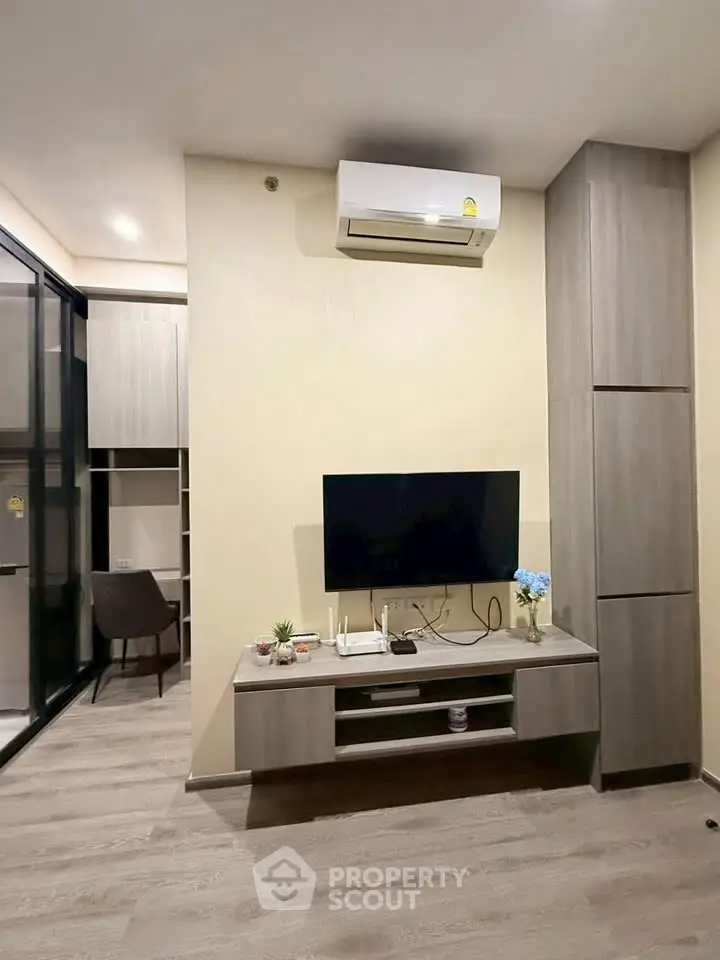 Modern living room with sleek TV setup and air conditioning