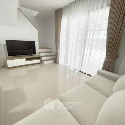 Spacious modern living room with sleek design and ample natural light