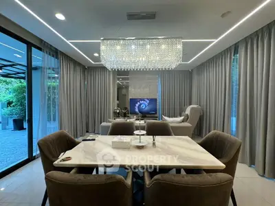 Luxurious modern living room with elegant dining area and stunning chandelier