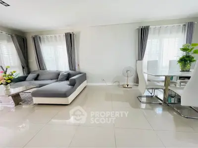 Spacious modern living room with elegant dining area and large windows
