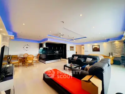 Spacious modern living room with open kitchen and stylish lighting