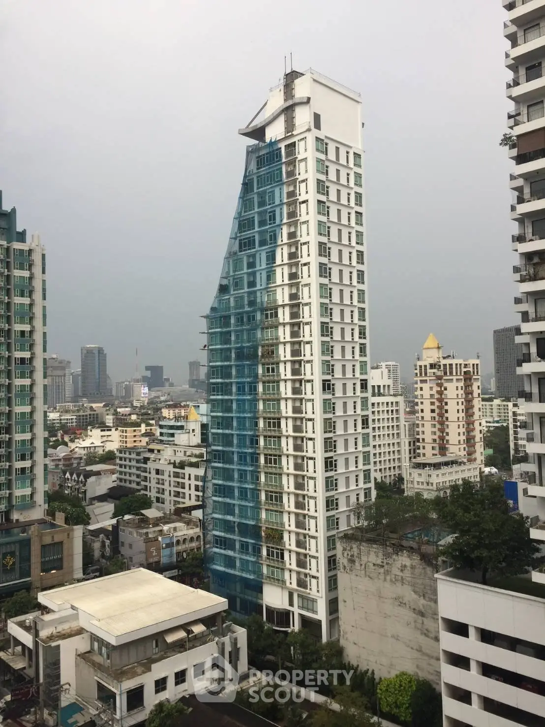 Stunning modern high-rise building with unique architectural design in urban skyline.