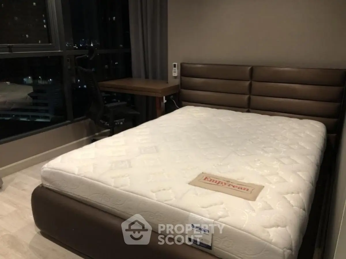 Cozy bedroom with modern furniture and large window view