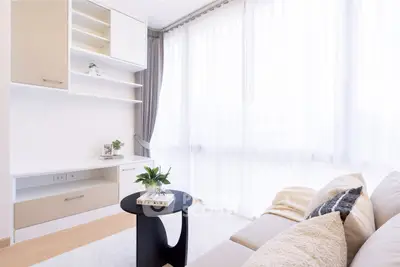 Bright and modern living room with elegant furniture and large windows.