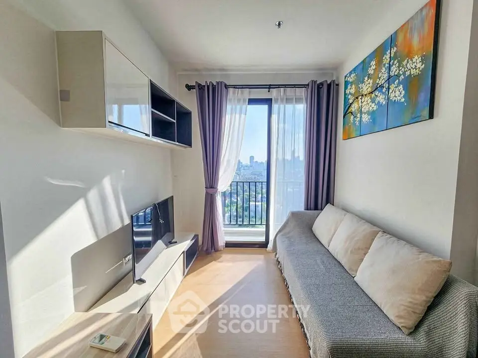 Bright and modern living room with balcony view, featuring sleek furniture and stylish decor.