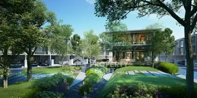 Modern residential complex with lush greenery and contemporary architecture.